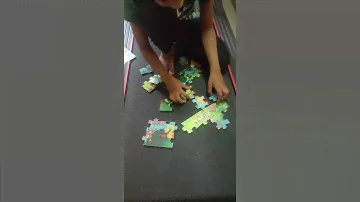 Aditya solving wooden animal puzzle on a treadmill.